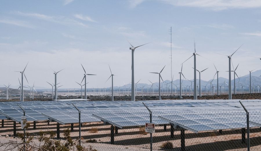 Wind turbines and a solar farm in a renewable energy landscape